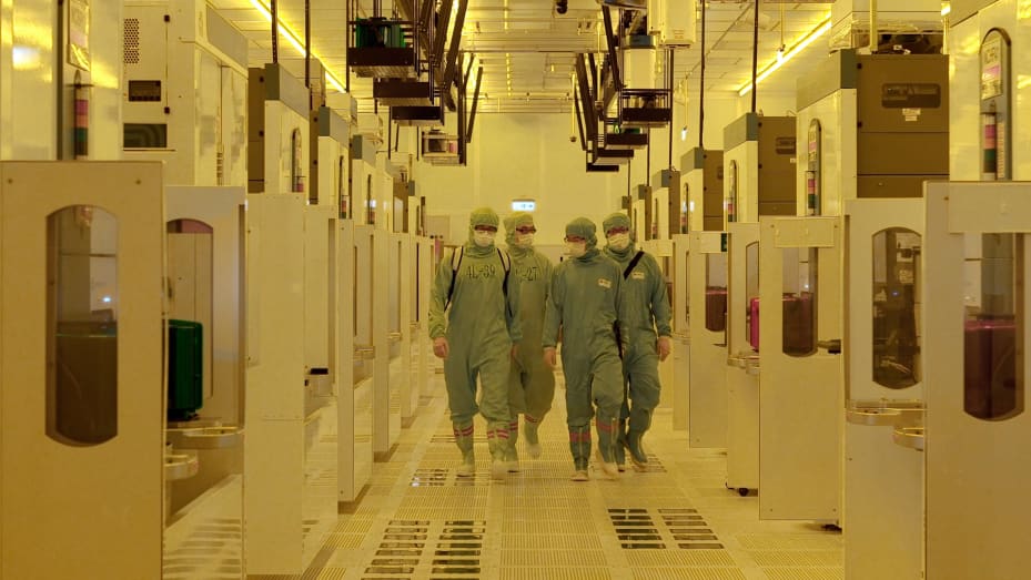 TSMC workers walk down a hallway in a chipmaking fab in Taiwan