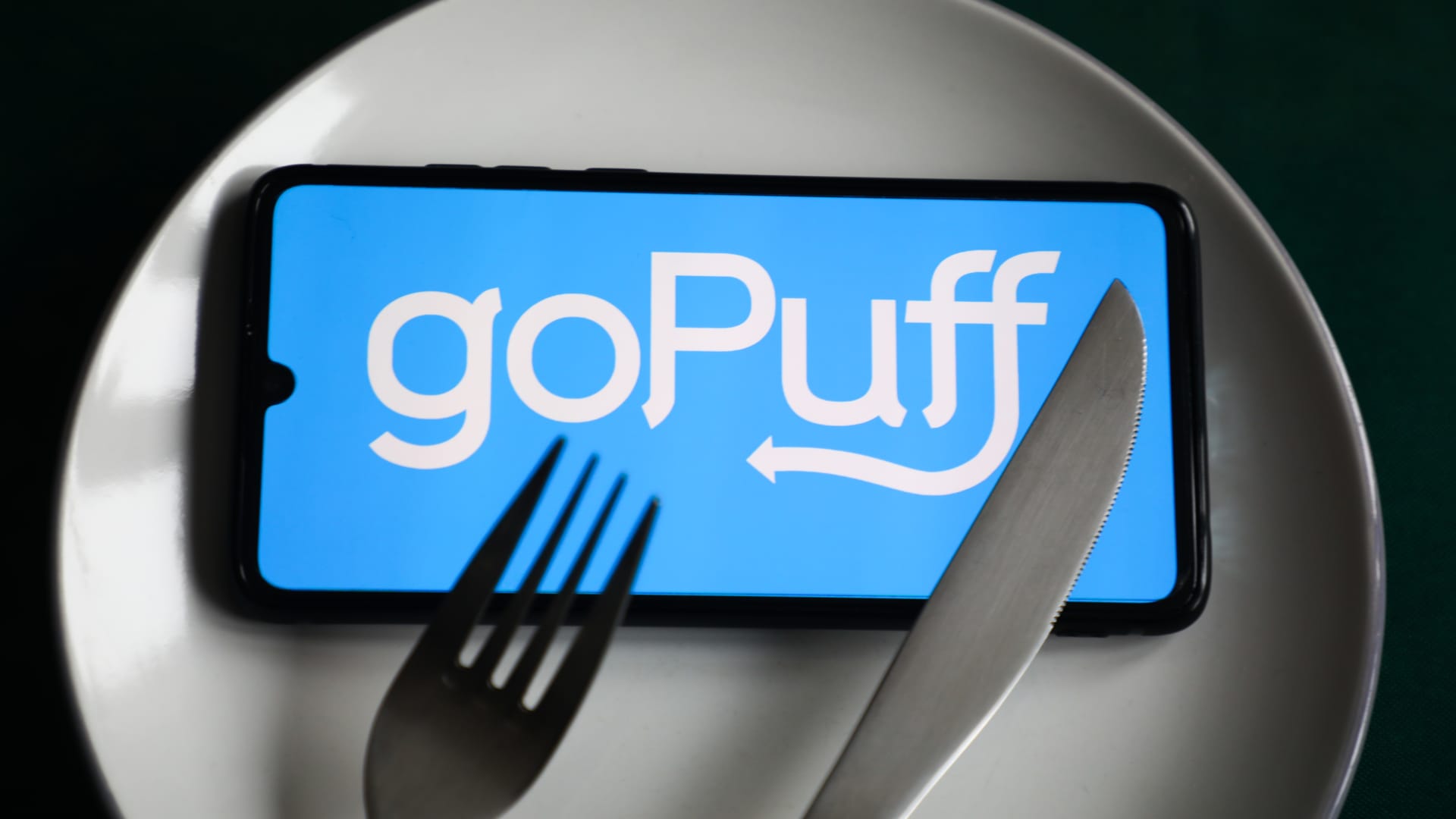 GoPuff app logo is displayed on a mobile phone screen.