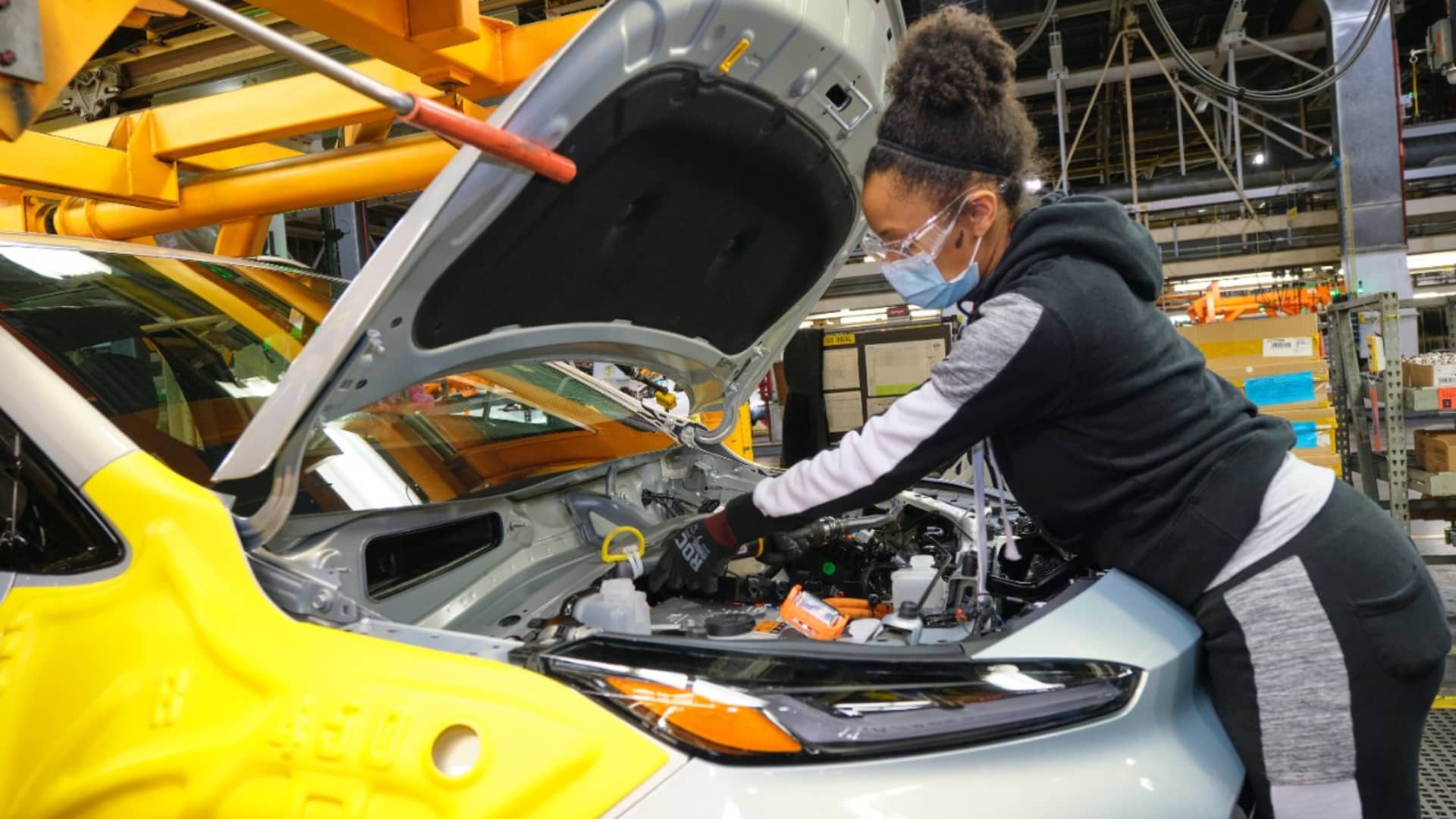 UAW Local 5960 member Kinethia Black fills the brakes of a 2022 Chevrolet Bolt EUV during vehicle production on Thursday, May 6, 2021 at the General Motors Orion Assembly Plant in Orion Township, Michigan.