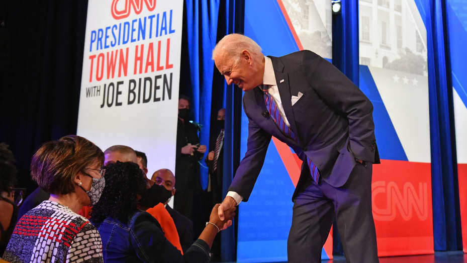 US President Joe Biden (R) greets attendees during a commercial break of a CNN town hall at Baltimore Center Stage in Baltimore, Maryland on October 21, 2021.