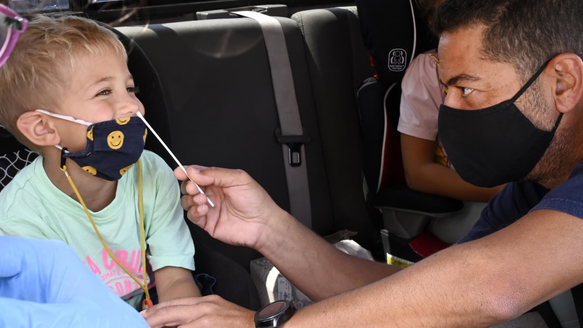 Mark Barsoun helps his son Jordan Barsous, 4, with the swab for a rapid COVID-19 test at Palos Verdes High School in Palos Verdes Estates on Tuesday, August 24, 2021.