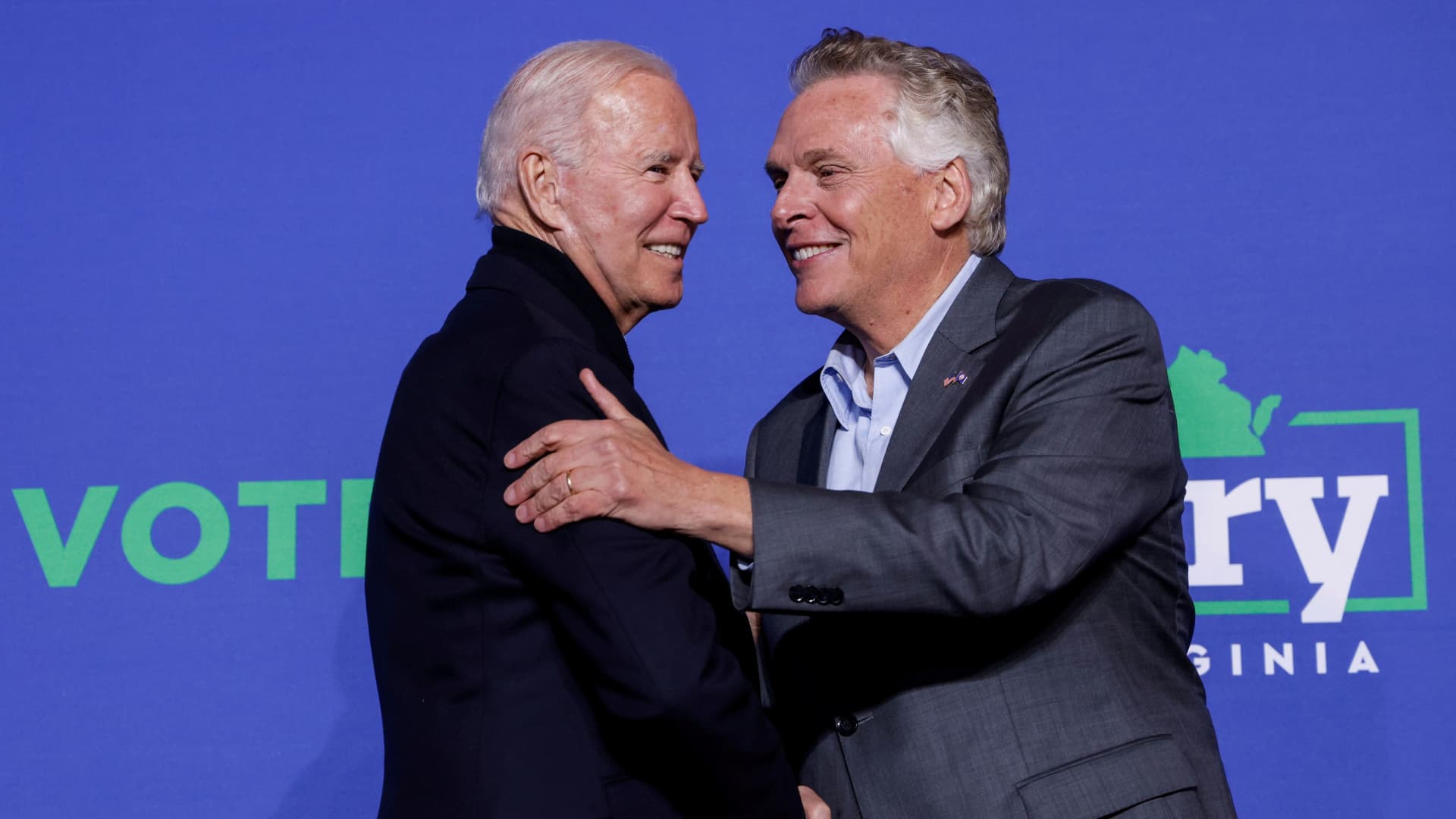 U.S. President Joe Biden and Democratic candidate for governor of Virginia Terry McAuliffe greet each other onstage at a rally in Arlington, Virginia, U.S. October 26, 2021.