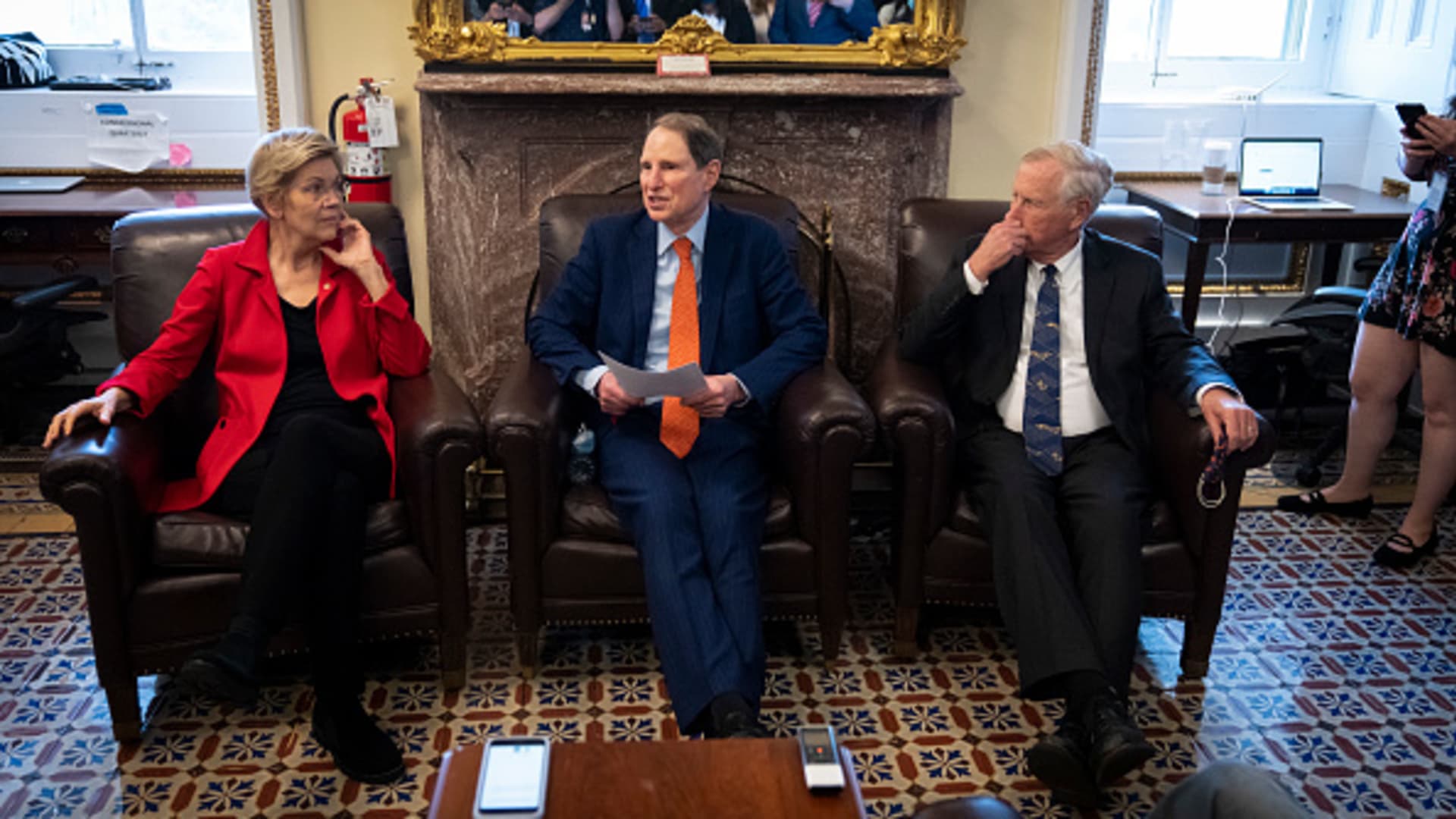(L-R) Sen. Elizabeth Warren (D-MA), Sen. Ron Wyden (D-OR) and Sen. Angus King (I-ME) speak to reporters about a corporate minimum tax plan at the U.S. Capitol October 26, 2021 in Washington, DC.