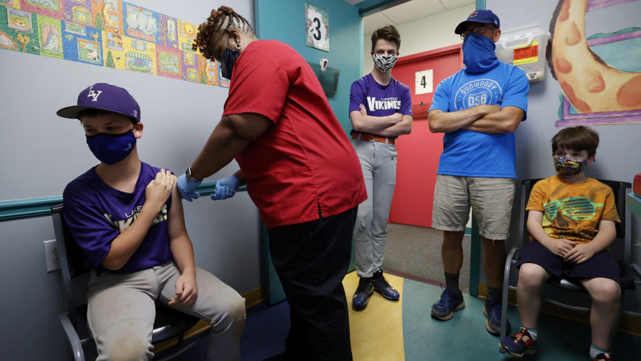 Family members look on as Jack Frilingos, 12, is inoculated with Pfizer's vaccine against coronavirus disease (COVID-19) after Georgia authorized the vaccine for ages over 12 years, at Dekalb Pediatric Center in Decatur, Georgia, U.S. May 11, 2021.