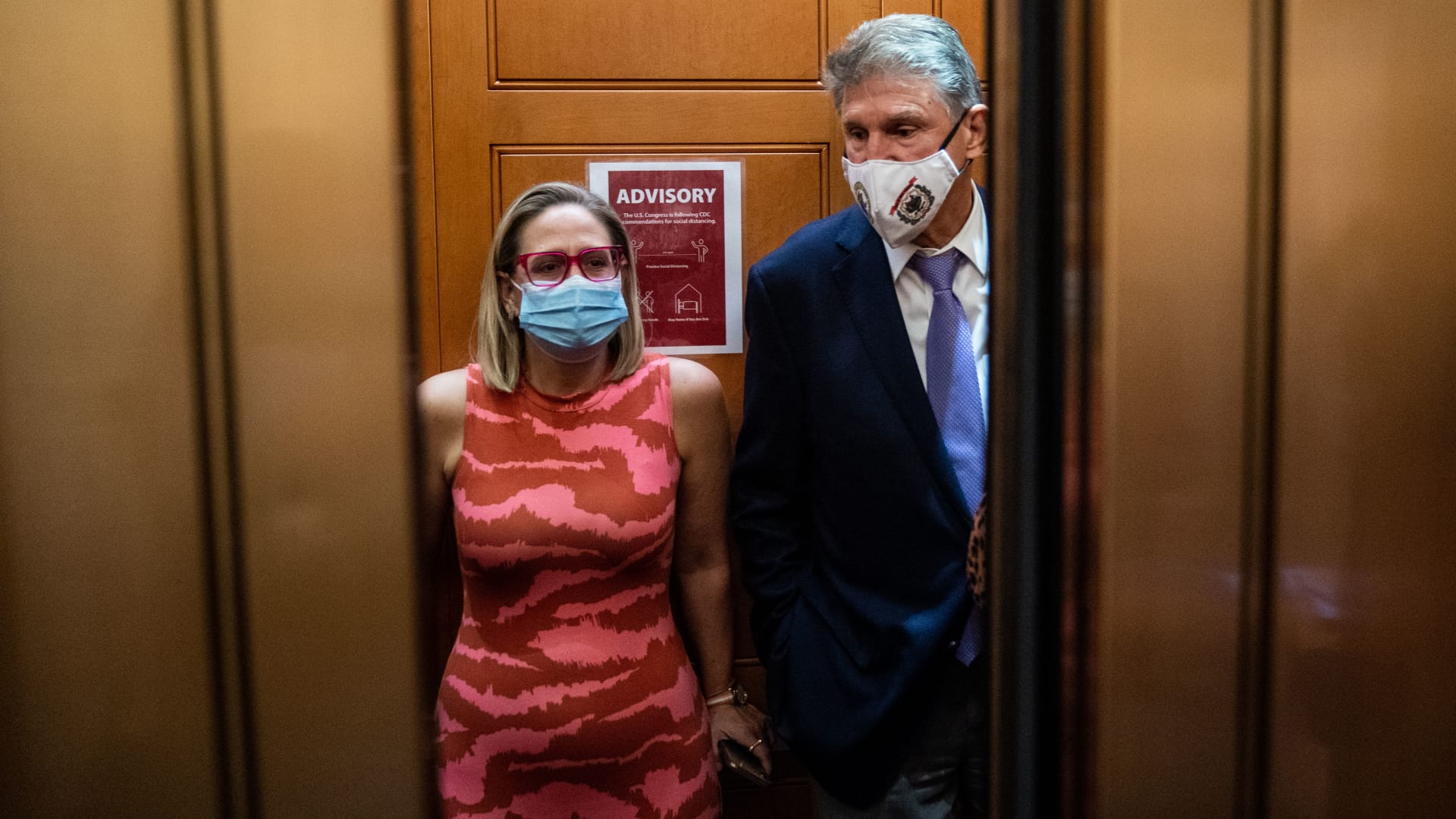 Sen. Kyrsten Sinema, D-Ariz., and Sen. Joe Manchin, D-W.Va., board an elevator after a private meeting between the two of them on Capitol Hill on Thursday, Sept. 30, 2021 in Washington, DC.