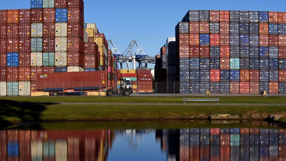 A truck picks up a shipping container at the Port of Savannah in Georgia. The supply chain crisis has created a backlog of nearly 80,000 shipping containers at this port, the third-largest container port in the United States, with around 20 ships anchored