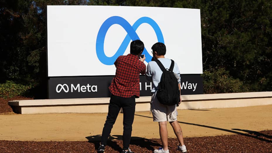 People take photos of the new "Meta" sign at the One Hacker Way in Menlo Park, as Facebook changes its company name to Meta in California, on October 28, 2021.