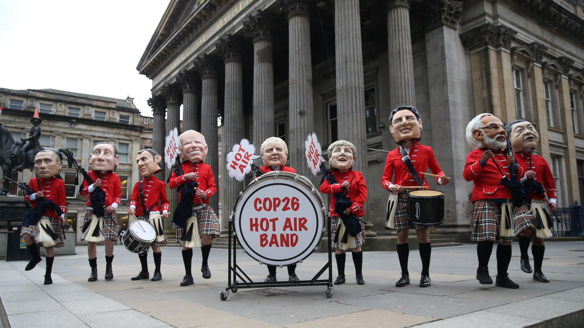 Oxfam activists dressed as world leaders take part in a protest at Royal Exchange Square during the COP26 summit in Glasgow on November 1, 2021.