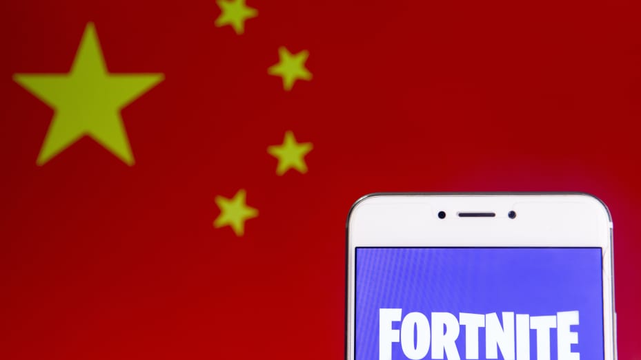 The Fortnite logo displayed on a smartphone with the flag of China shown in the background.