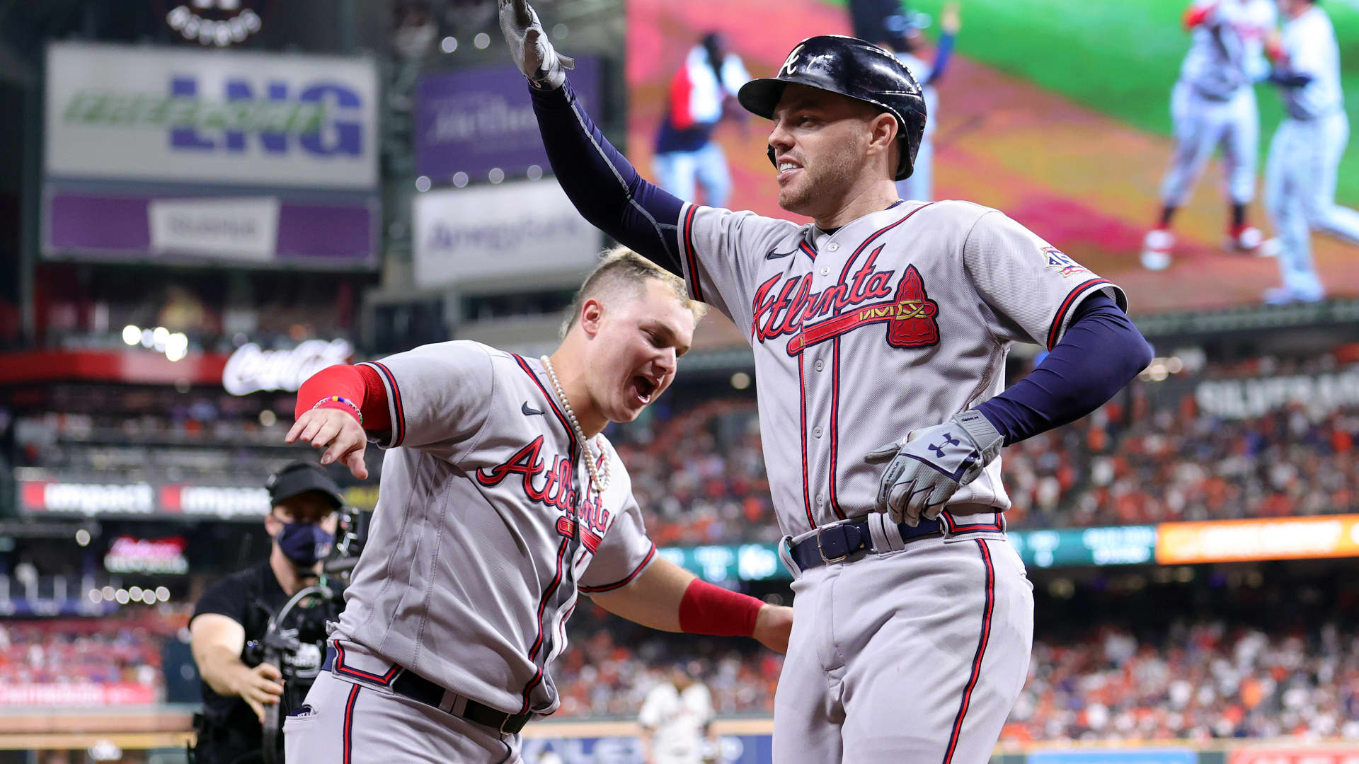 Freddie Freeman #5 of the Atlanta Braves celebrates with Joc Pederson #22 after hitting a solo home run against the Houston Astros during the seventh inning in Game Six of the World Series at Minute Maid Park on November 02, 2021 in Houston, Texas.