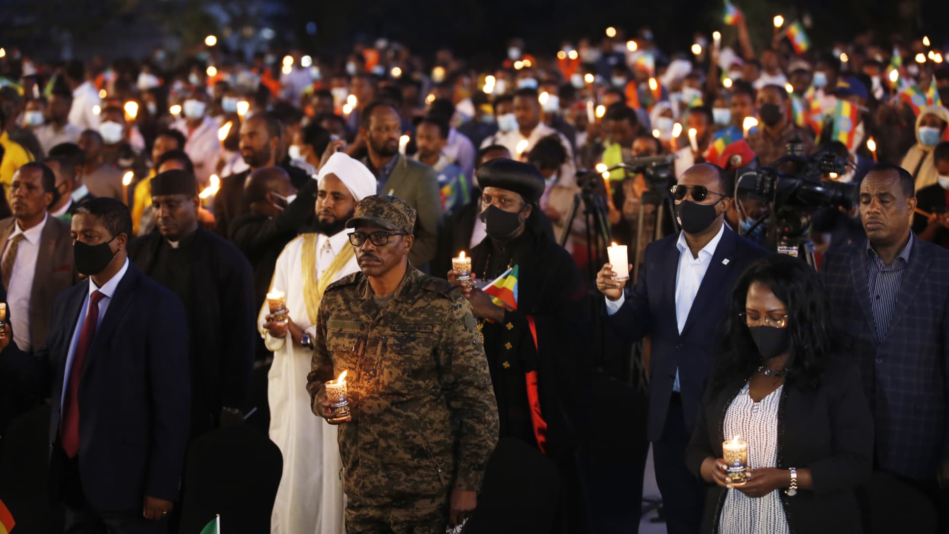 People hold lit candles in a memorial service for victims of the Tigray conflict organized by the city administration, in Addis Ababa, Ethiopia, on November 3, 2021.