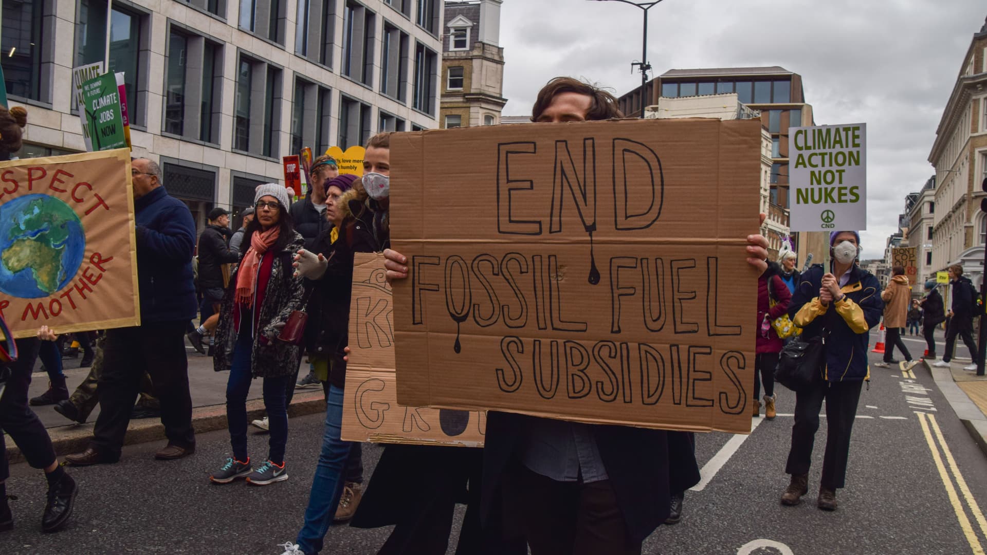 A protester holds an 'End Fossil Fuel Subsidies' placard during the demonstration in the City of London.
