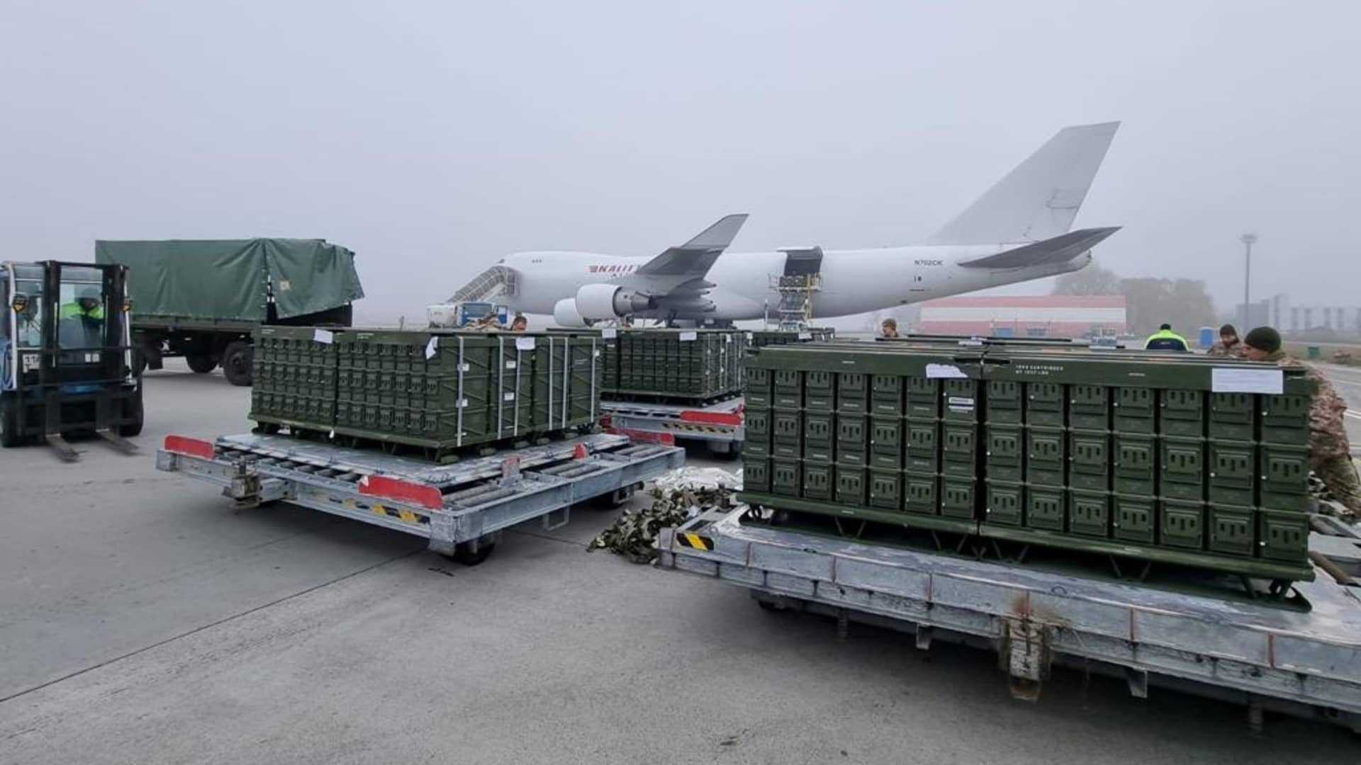 Workers and Ukrainian servicemen unload a shipment of ammunition delivered as part of the United States of America's security assistance to Ukraine, at the Boryspil International Airport outside Kyiv, Ukraine November 14, 2021.