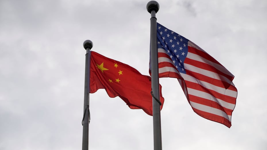 Chinese and U.S. flags flutter outside a company building in Shanghai, China November 16, 2021.