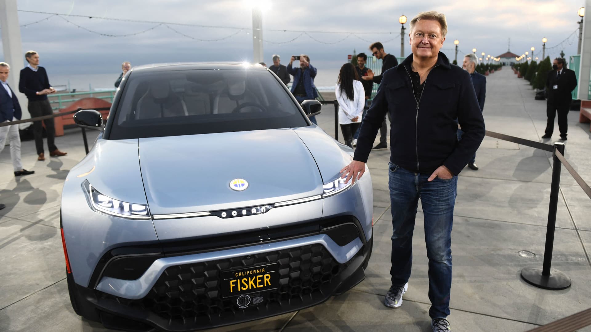Henrik Fisker stands with the Fisker Ocean electric vehicle after it was unveiled at the Manhattan Beach Pier ahead of the Los Angeles Auto Show and AutoMobilityLA on November 16, 2021 in Manhattan Beach, California.