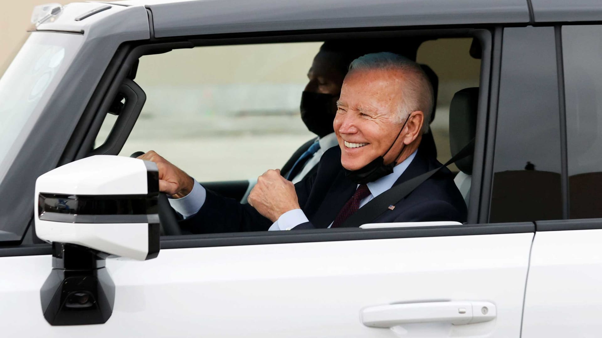 U.S. President Joe Biden gestures after driving a Hummer EV during a tour at the General Motors 'Factory ZERO' electric vehicle assembly plant in Detroit, Michigan, November 17, 2021.