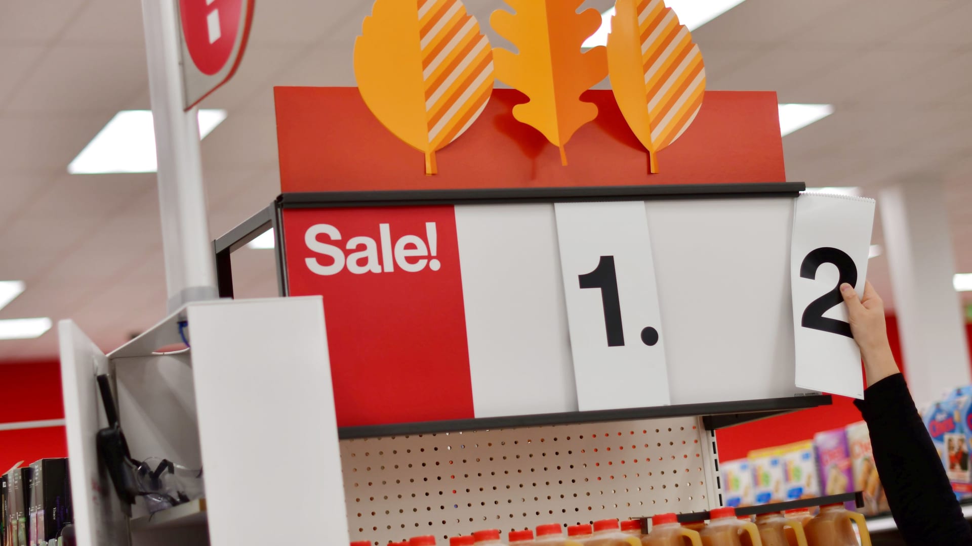 An employee alters the sale price of merchandise on a sign at a Target store in King of Prussia, Pennsylvania, November 20, 2020.