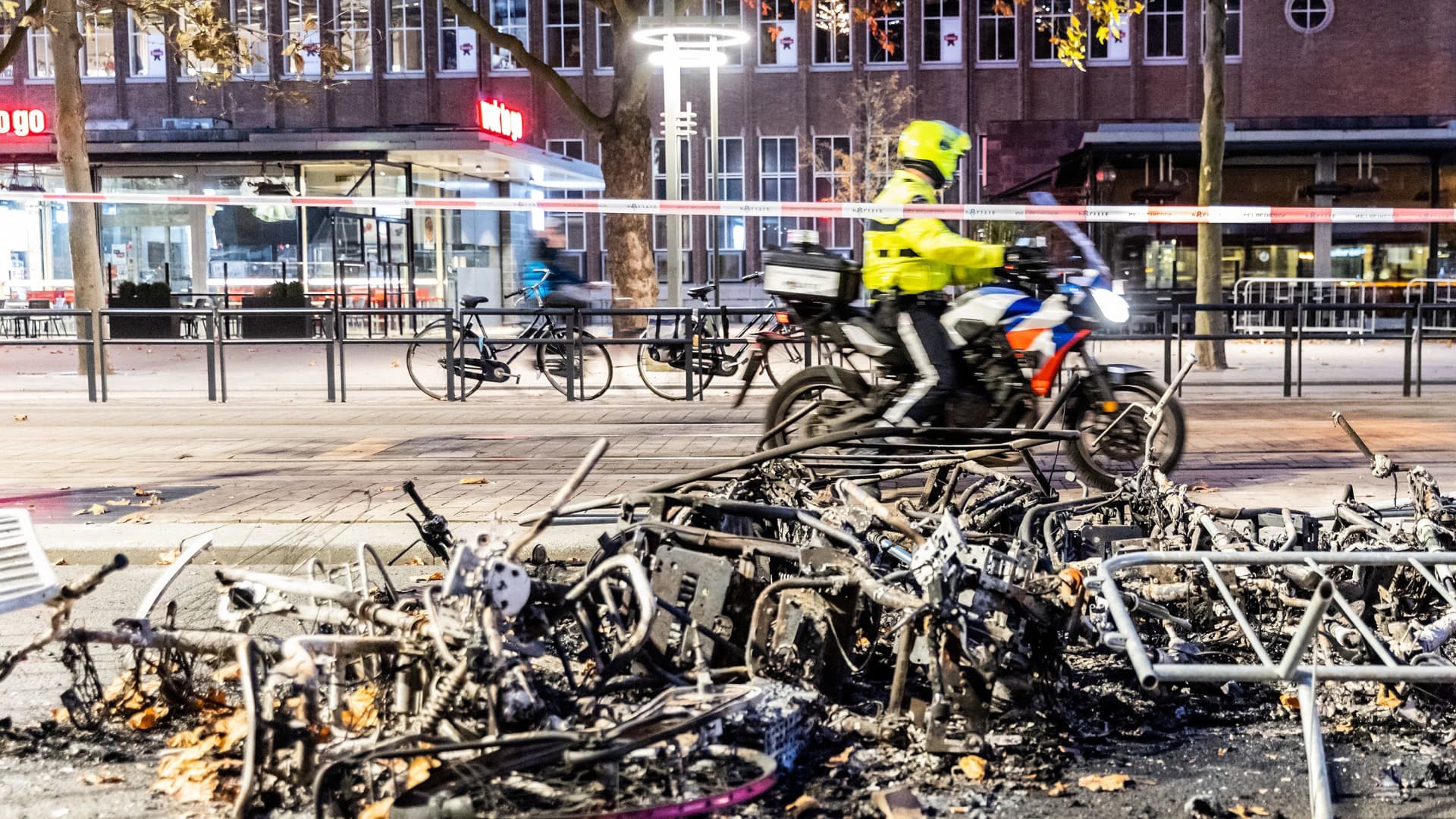 This photograph taken on November 20, 2021 shows burned bikes after a protest against the partial lockdown and against the 2G government policy in Rotterdam.