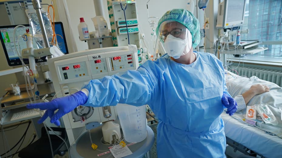 A nurse instructs a colleague while tending to a Covid patient in the Covid intensive care unit at Leipzig university hospital.