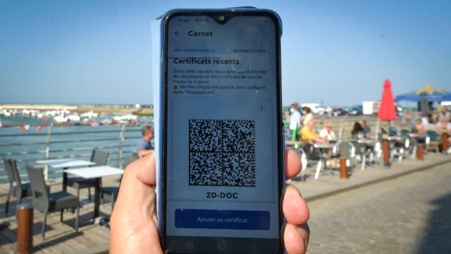 QR code with EU COVID digital certificate displayed on a mobile phone.