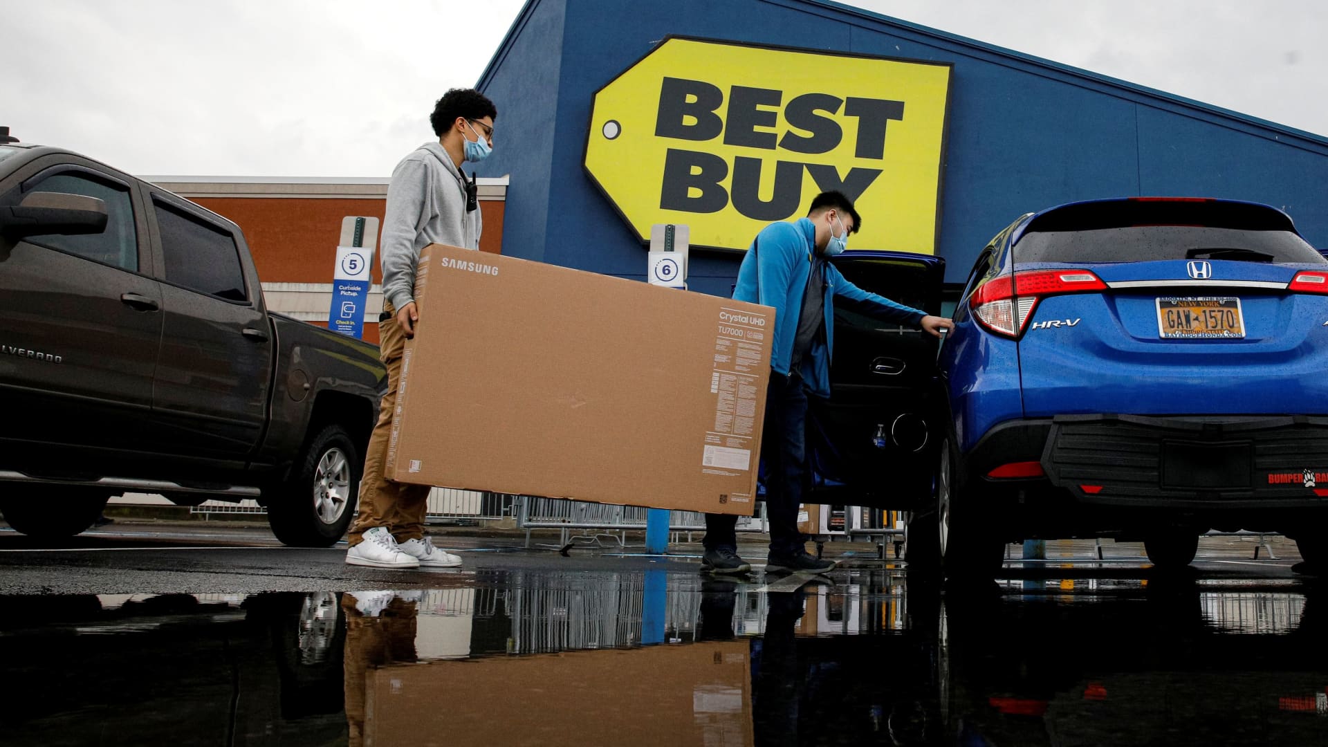 Shoppers exit a Best Buy store during Black Friday sales in Brooklyn, New York, November 26, 2021.