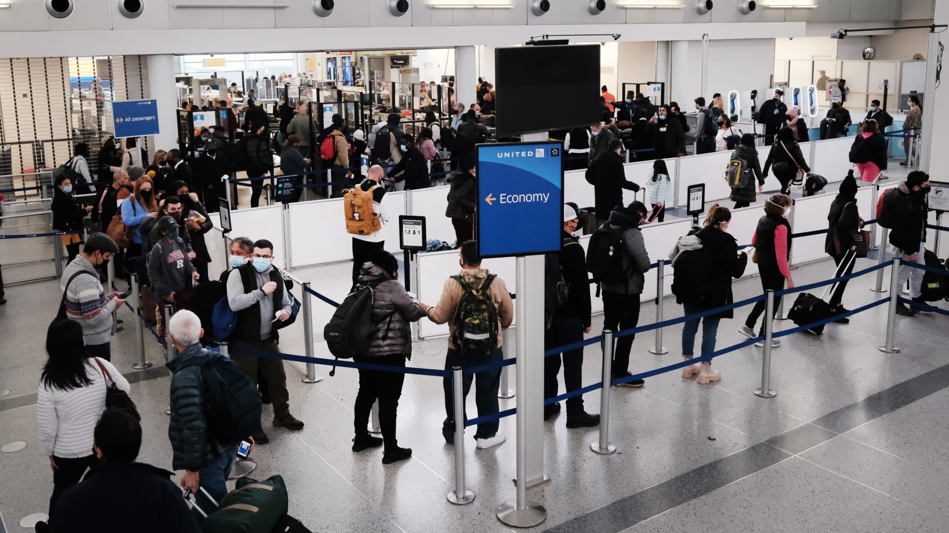 Travelers arrive for flights at Newark Liberty International Airport on November 30, 2021 in Newark, New Jersey.