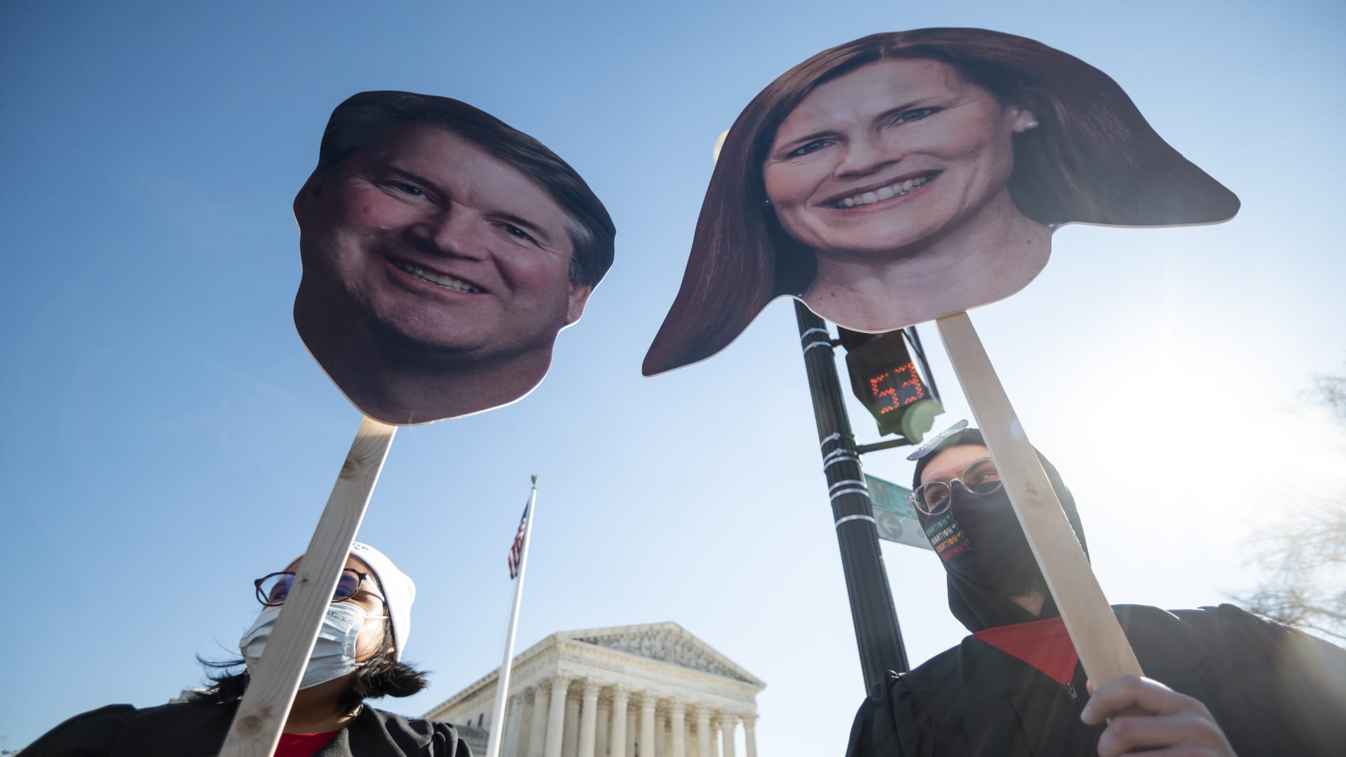 Reproductive rights activists hold cut out photos of Justices Brett Kavanaugh and Amy Coney Barrett as oral arguments in Dobbs v. Jackson Womens Health Organization case are held on Wednesday, December 1, 2021.