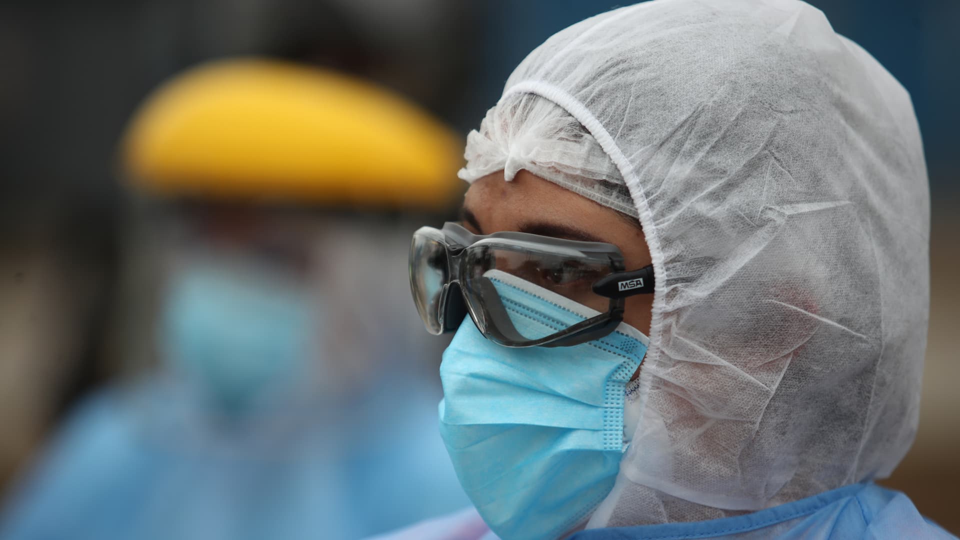 Doctor wearing PPE looks on before a house-to-house coronavirus testing drive on July 21, 2020 in Lima, Peru.