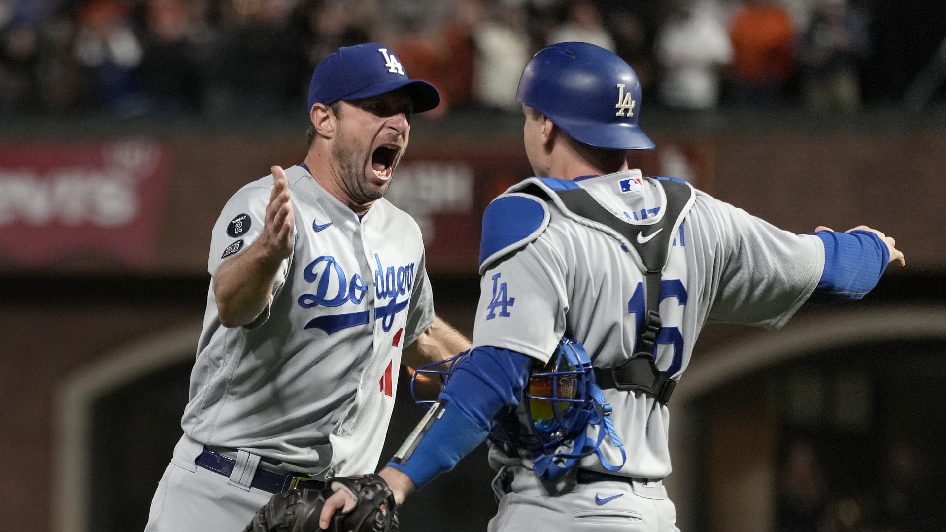 Max Scherzer, left, and Will Smith of the Los Angeles Dodgers celebrate after beating the San Francisco Giants 2-1 in game 5 of the National League Division Series at Oracle Park on October 14, 2021 in San Francisco, California.