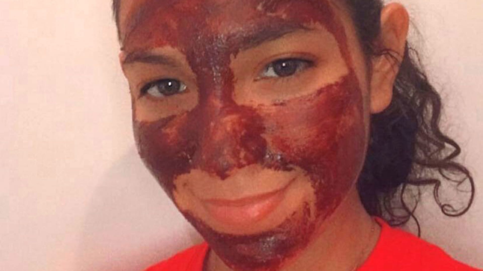 Alexis Larreategui wearing a chocolate face mask from her vegan skin care brand.