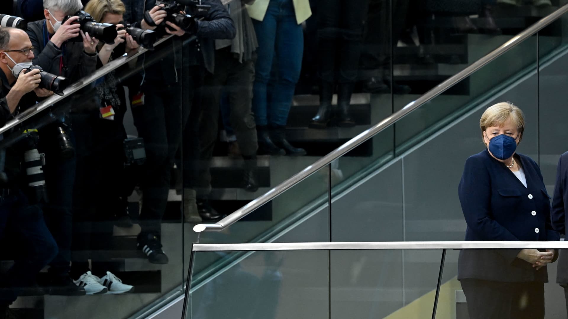 Outgoing German Chancellor Angela Merkel is in the focus of photographers as she stands on the tribune prior to a session at the Bundestag in Berlin.