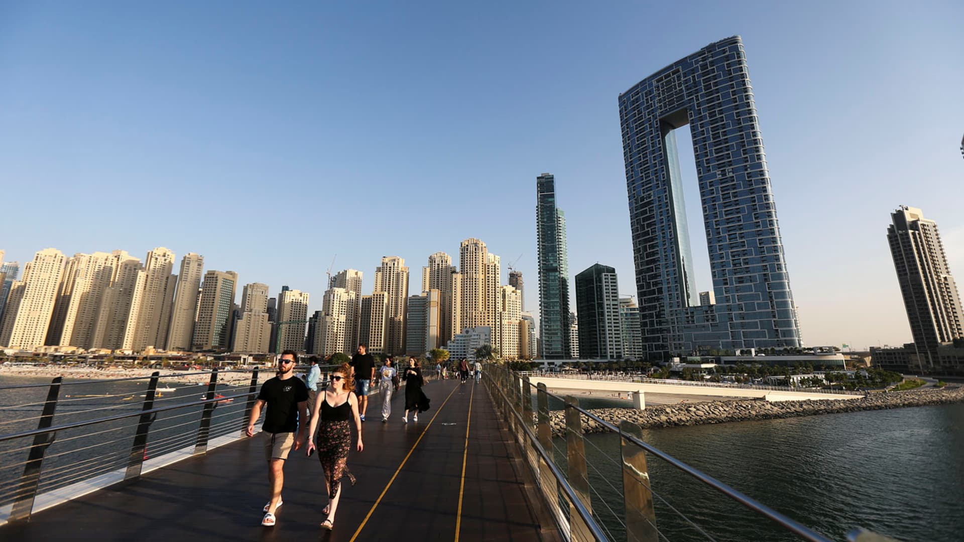 People walk on the Pedestrian Bridge at the Bluewaters Island in Dubai, United Arab Emirates, December 08, 2021.