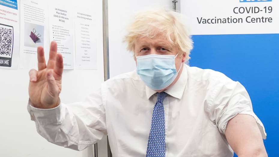 Britain's Prime Minister Boris Johnson gestures while visiting St Thomas Hospital to receive his coronavirus booster vaccination, in London, Britain December 2, 2021.