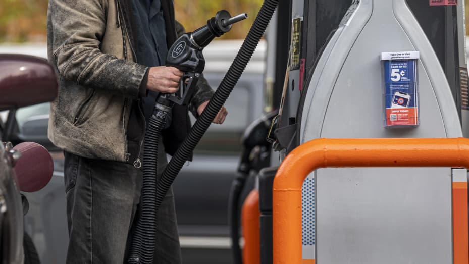 A customer holds a fuel pump nozzle at a 76 gas station in San Francisco, California, on Nov. 15, 2021.
