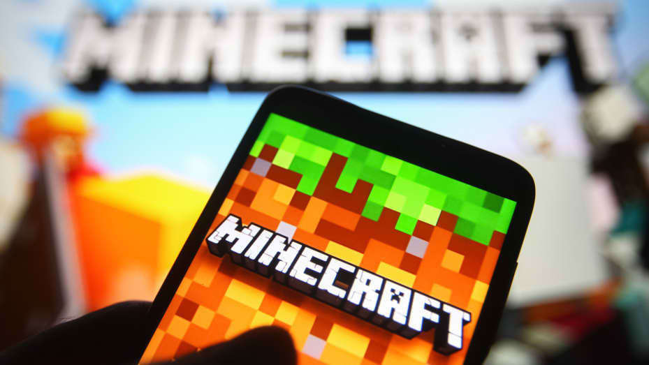 In this photo illustration a Minecraft logo is seen on a smartphone screen.