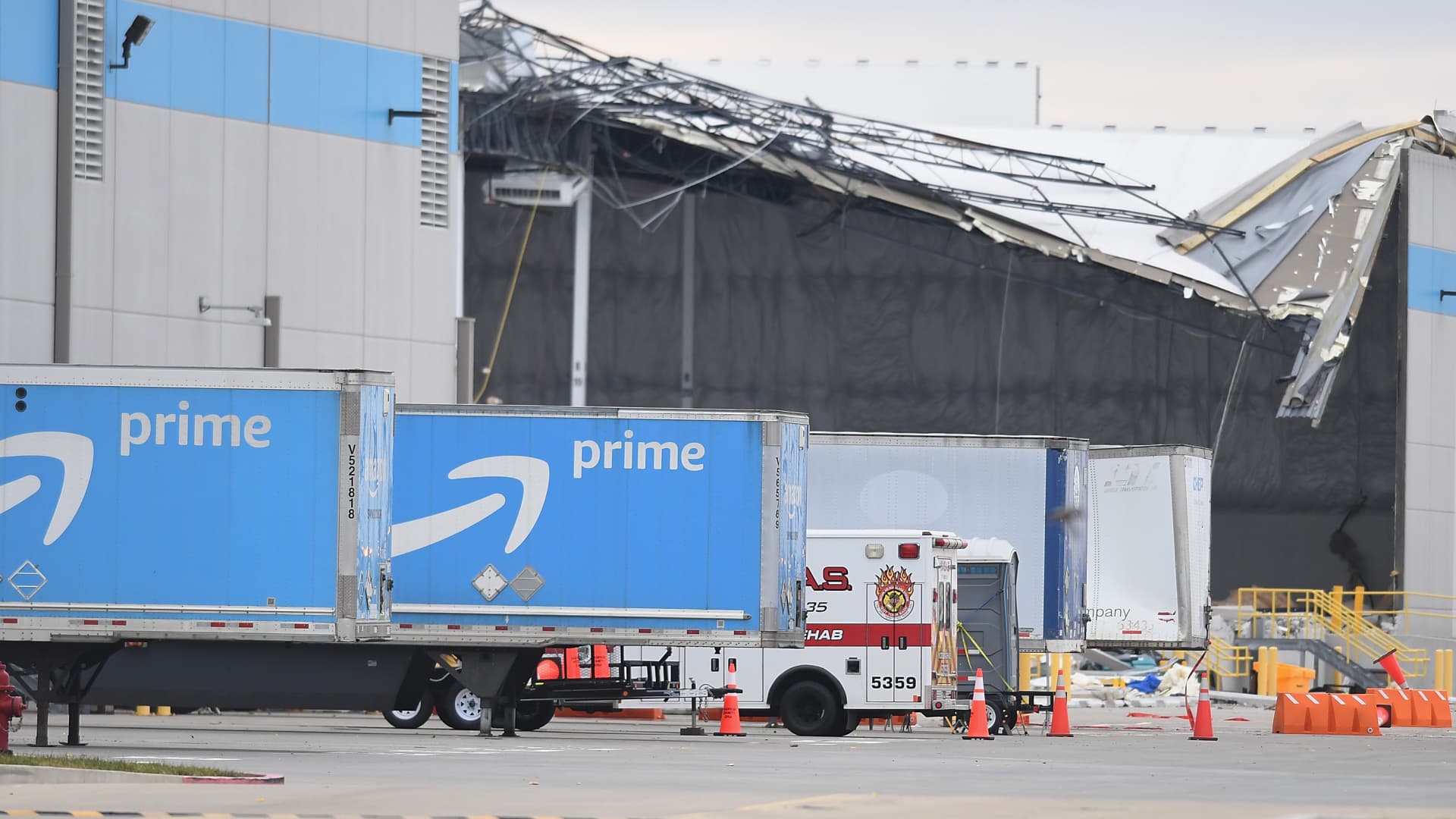 Amazon truck cabs are seen outside a damaged Amazon Distribution Center on December 11, 2021 in Edwardsville, Illinois. According to reports, the Distribution Center was struck by a tornado Friday night.