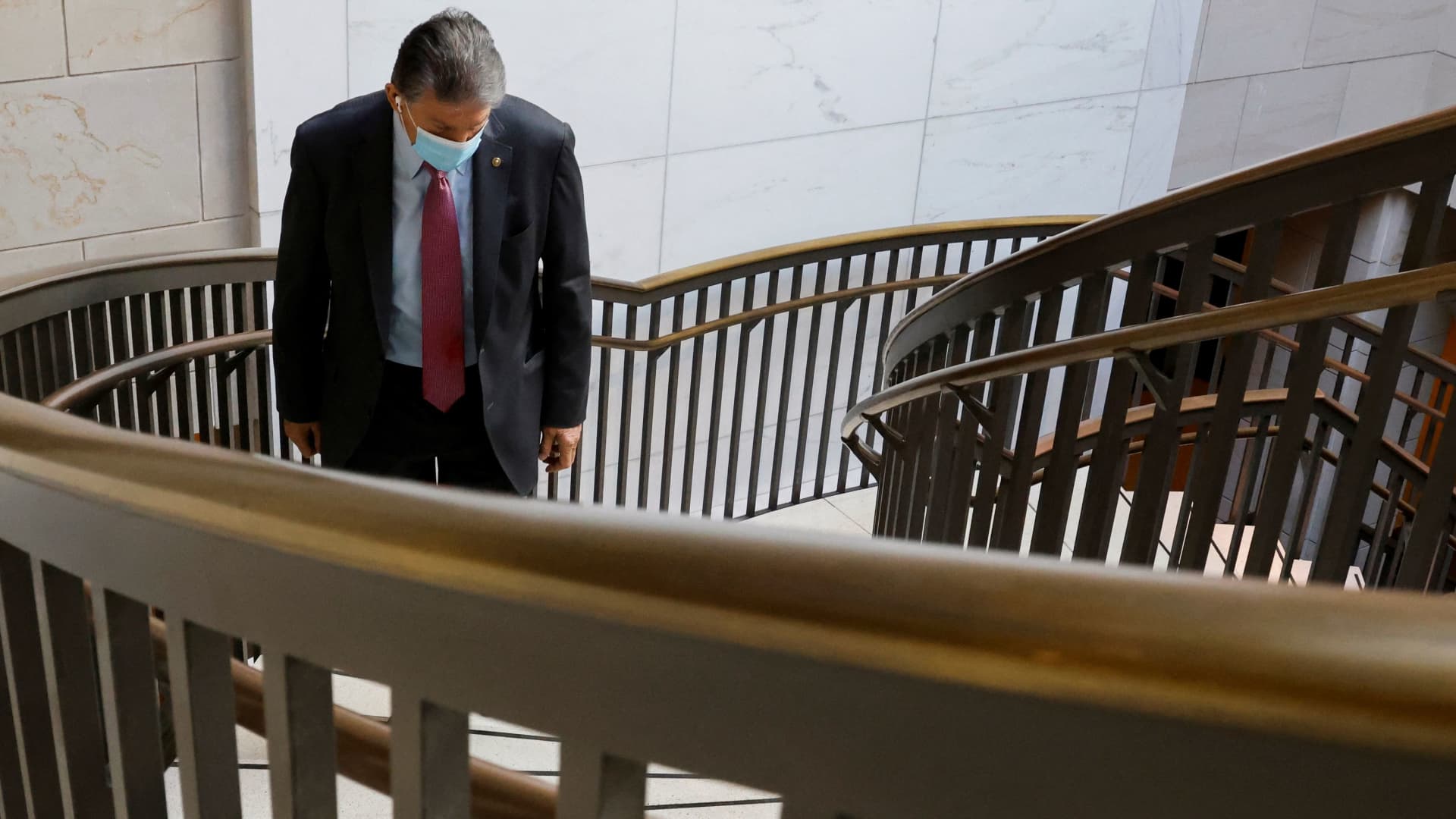 U.S. Senator Joe Manchin (D-WV) walks between meetings at the Capitol in the midst of ongoing negotiations over the Build Back Better bill, which aims to bolster the social safety net and fight climate change, in Washington, U.S. December 14, 2021.