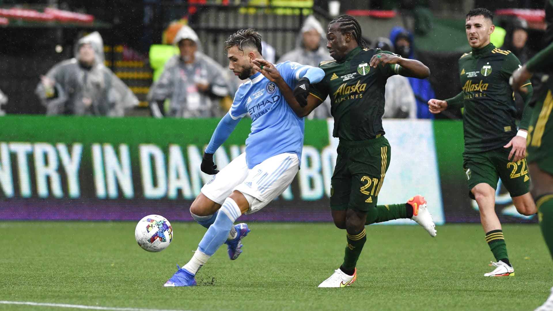 New York City FC forward Valentín Castellanos (11) passes the ball forward against Portland Timbers midfielder Diego Chara (21) during the MLS Cup Final between the Portland Timbers and New York City FC on December 11, 2021 at Providence Park in Portland, Oregon.