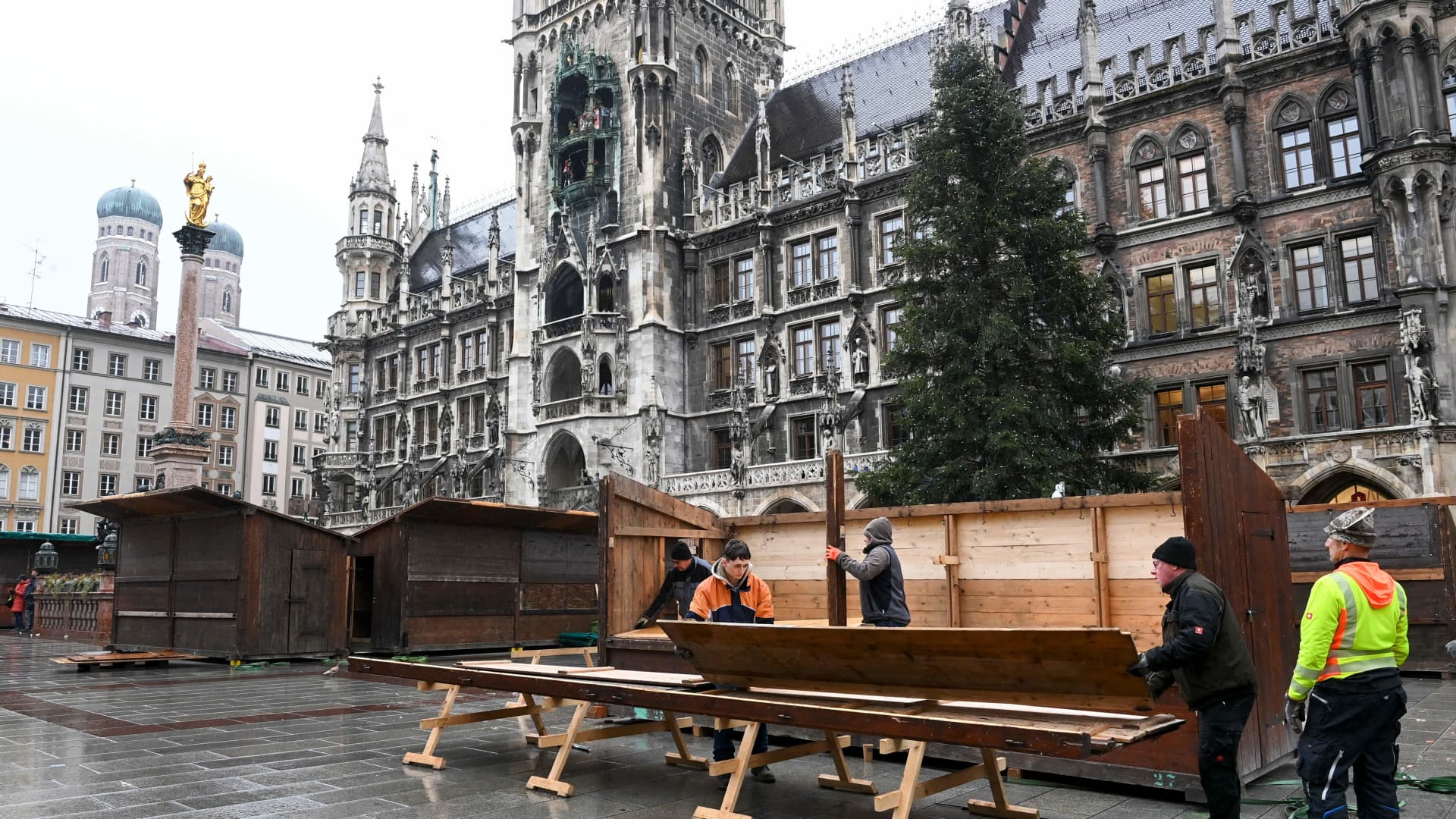 Workers dismantle a Christmas market booth at the Marienplatz in the center of Munich, southern Germany, on November 22, 2021.