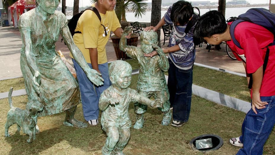 A sculpture in Manila pays tribute to overseas Filipino workers, many of whom are parents who spend years away from their children and loved ones to earn wages to financially support them.