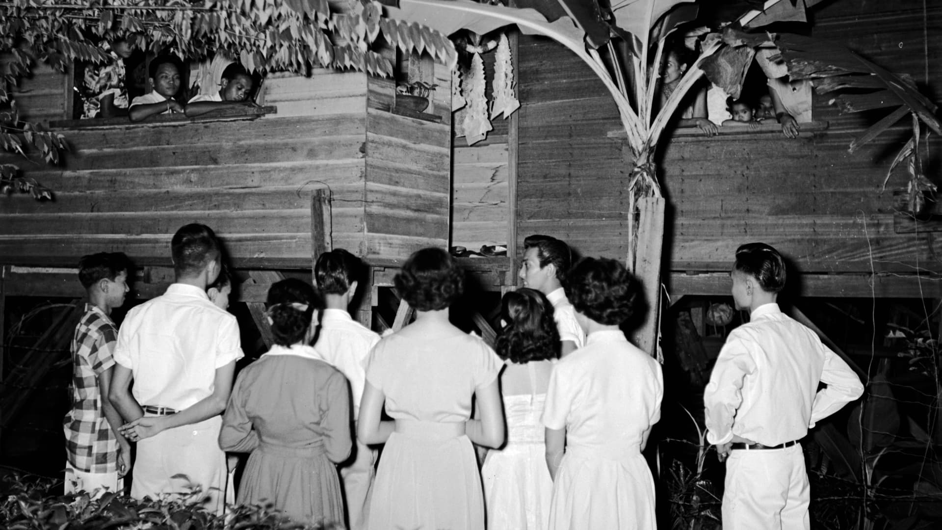 Joven Cuanang said when he was growing up in Ilocos in Luzon, children went house-to-house singing Christmas carols in exchange for tupig, a type of sweet rice cake, like the young Filipino carolers, circa 1955, shown here.