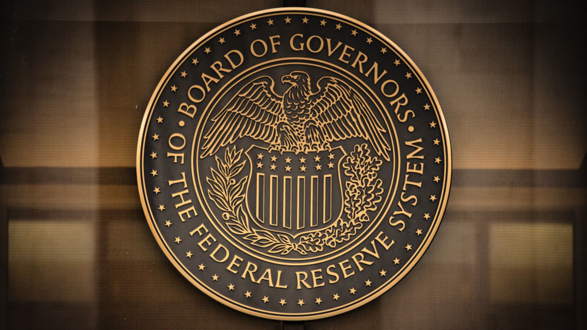 The seal of the U.S. Federal Reserve Board of Governors across the street from the Marriner S. Eccles Federal Reserve building in Washington, D.C., U.S., on Sunday, Dec. 19, 2021.