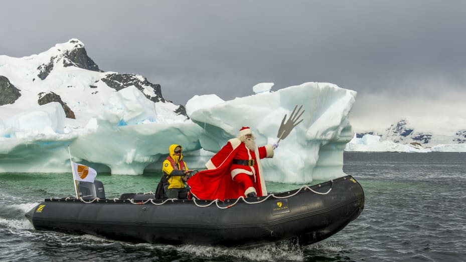 A man dressed as Santa Claus is en route to visit the cruise ship Seabourn Quest on Christmas morning at Cuverville Island in the Antarctic Peninsula region.