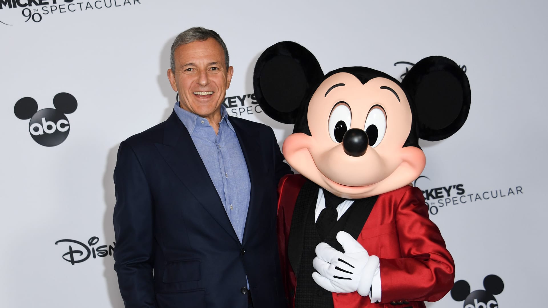 Bob Iger poses with Mickey Mouse attends Mickey's 90th Spectacular at The Shrine Auditorium on October 6, 2018 in Los Angeles.