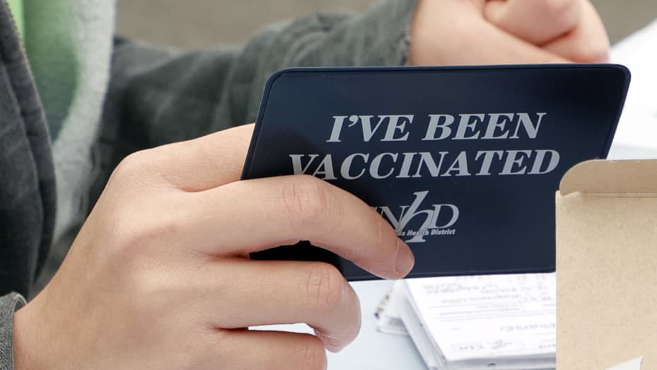 A Covid-19 vaccination card holder is handed out at a pop-up Covid-19 vaccination clinic at Larry Flynt's Hustler Club on December 21, 2021 in Las Vegas, Nevada.