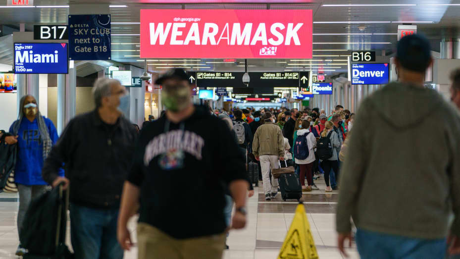 A sign reads "Wear A Mask" at the Hartsfield-Jackson Atlanta International Airport (ATL) in Atlanta, Georgia, U.S., on Tuesday, Dec. 21, 2021.