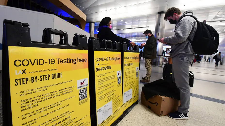 A man checks in at a Covid-19 testing site in the international arrivals area of Los Angeles International Airport in Los Angeles, California on December 22, 2021.