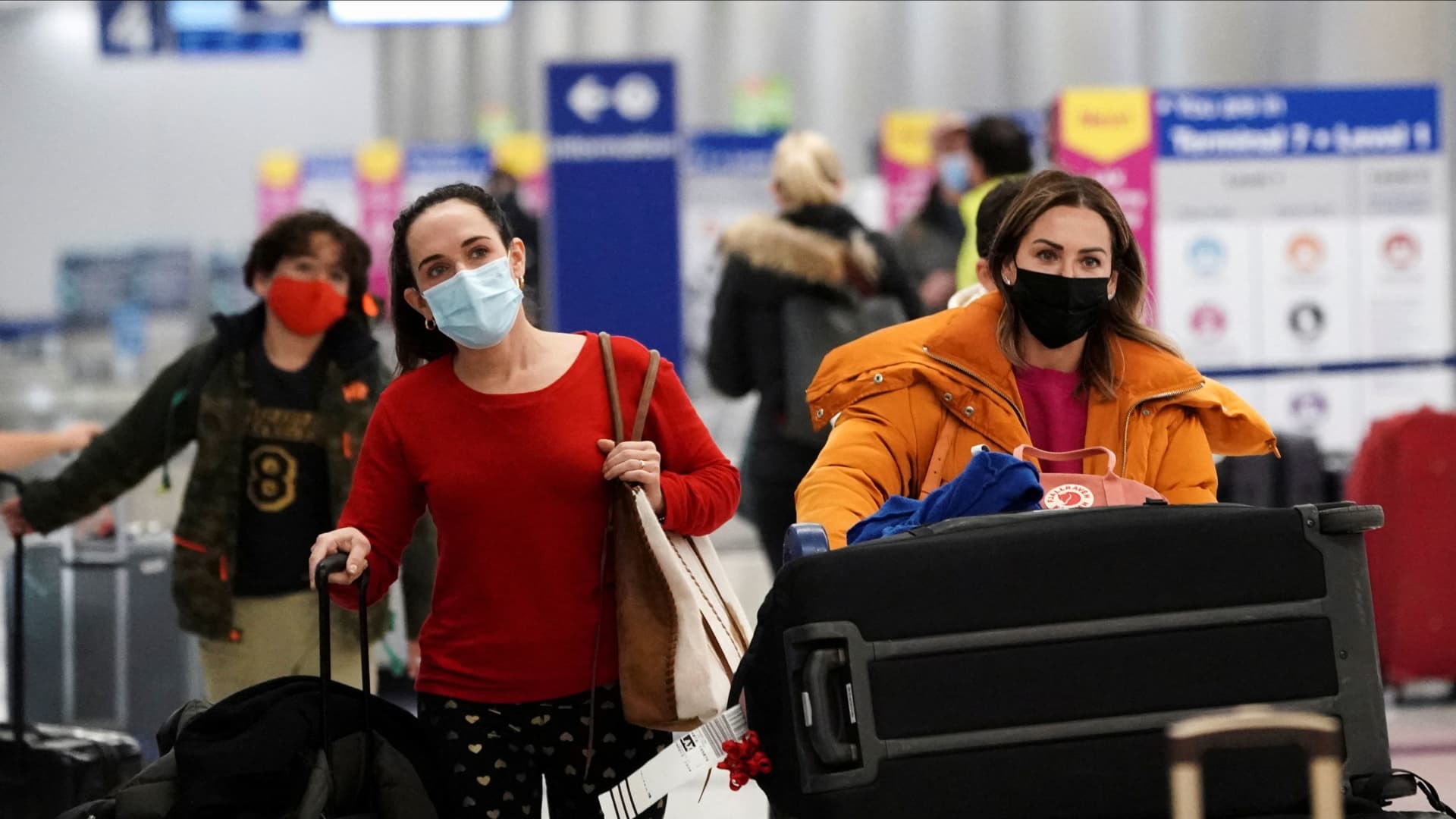 Travelers push their luggage past baggage claim inside the United Airlines terminal at Los Angeles International Airport (LAX) during the holiday season as the coronavirus disease (COVID-19) Omicron variant threatens to increase case numbers in Los Angeles, California, U.S. December 22, 2021.