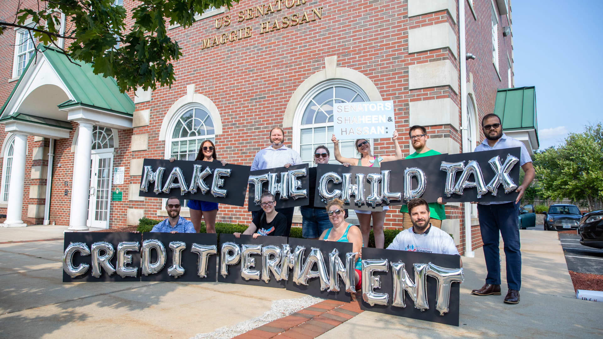 New Hampshire parents and others gather outside of Sen. Maggie Hassan's Manchester office on Sept, 14, 2021..