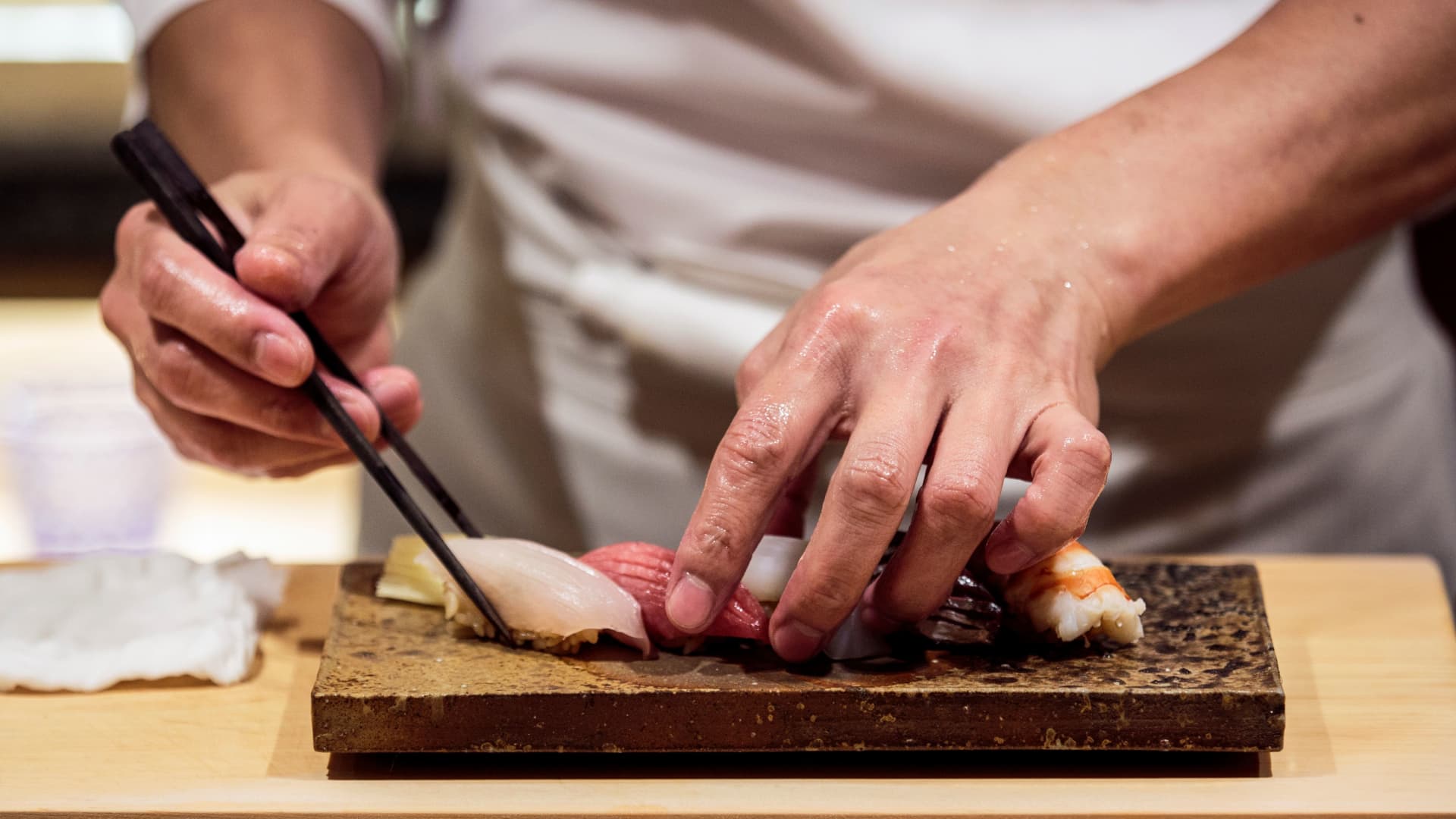 A chef prepares sushi at a restaurant in Tokyo, Japan.